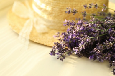 Photo of Beautiful lavender flowers and straw hat on window sill, closeup