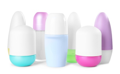 Photo of Different female roll-on deodorants on white background. Skin care