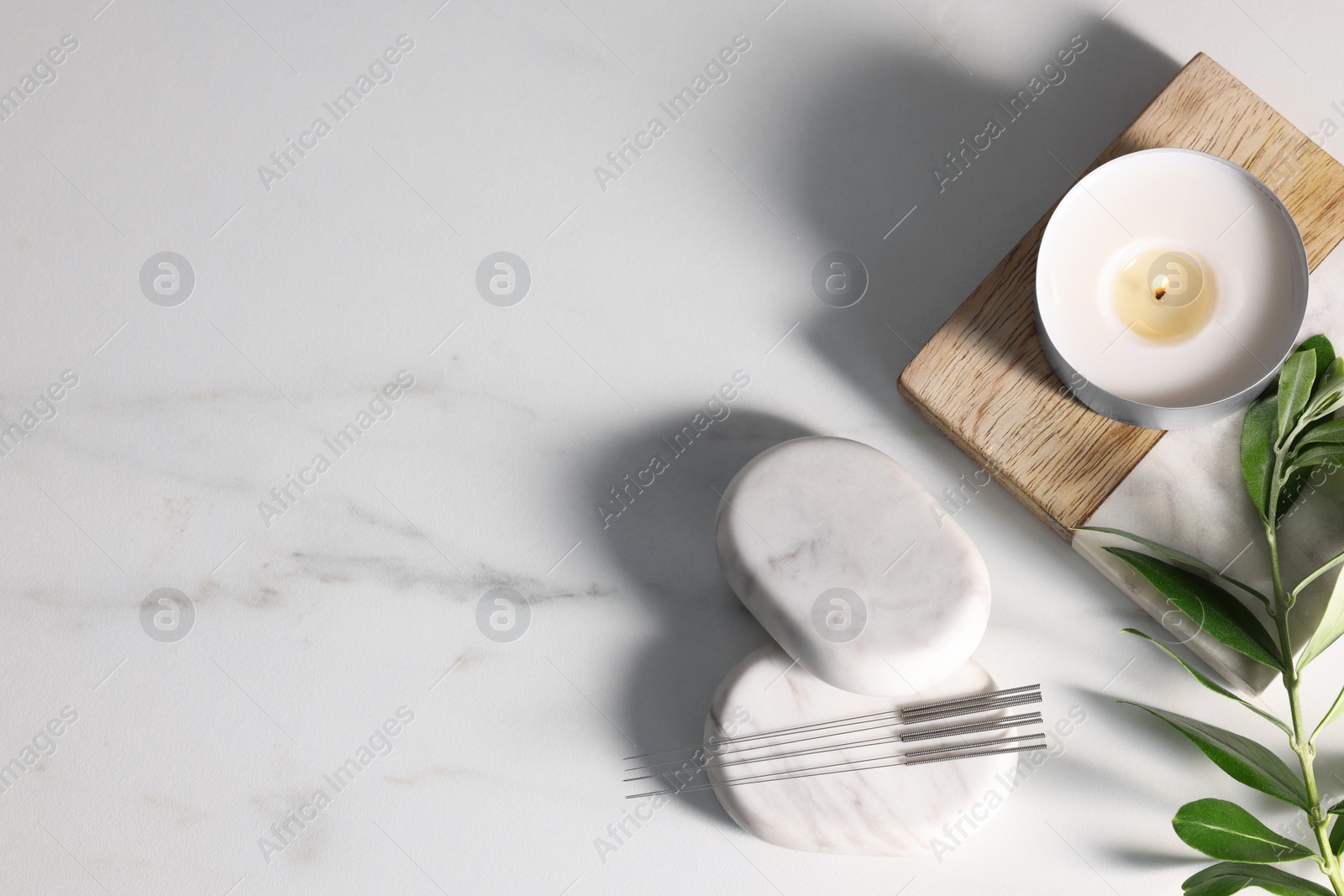 Photo of Flat lay composition with acupuncture needles on white marble table, space for text