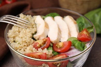 Photo of Delicious quinoa salad with chicken and cherry tomatoes served on table, closeup