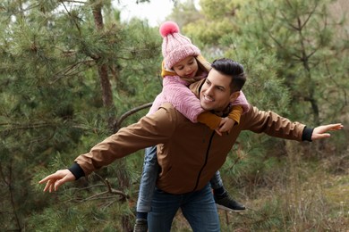 Photo of Man and his daughter spending time together in forest