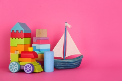 Photo of Set of different toys on pink background. Space for text