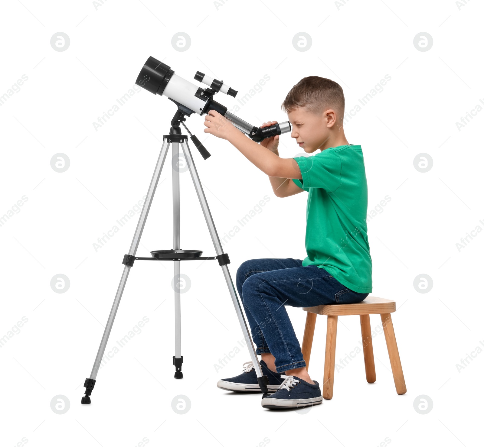 Photo of Little boy looking at stars through telescope on white background