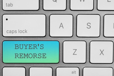 Button with text Buyer's Remorse on computer keyboard, top view