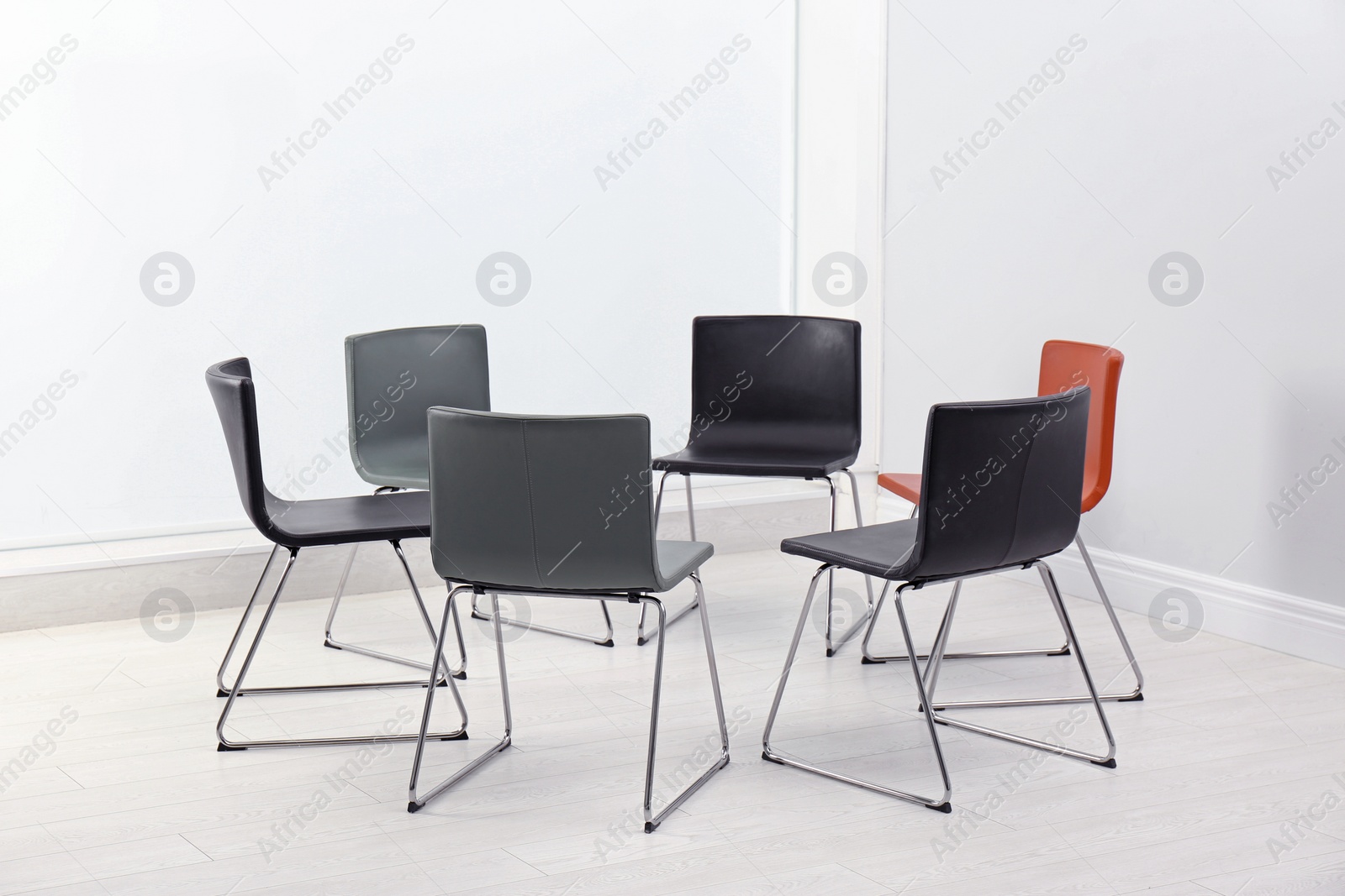 Photo of Chairs prepared for group therapy session in office. Meeting room interior