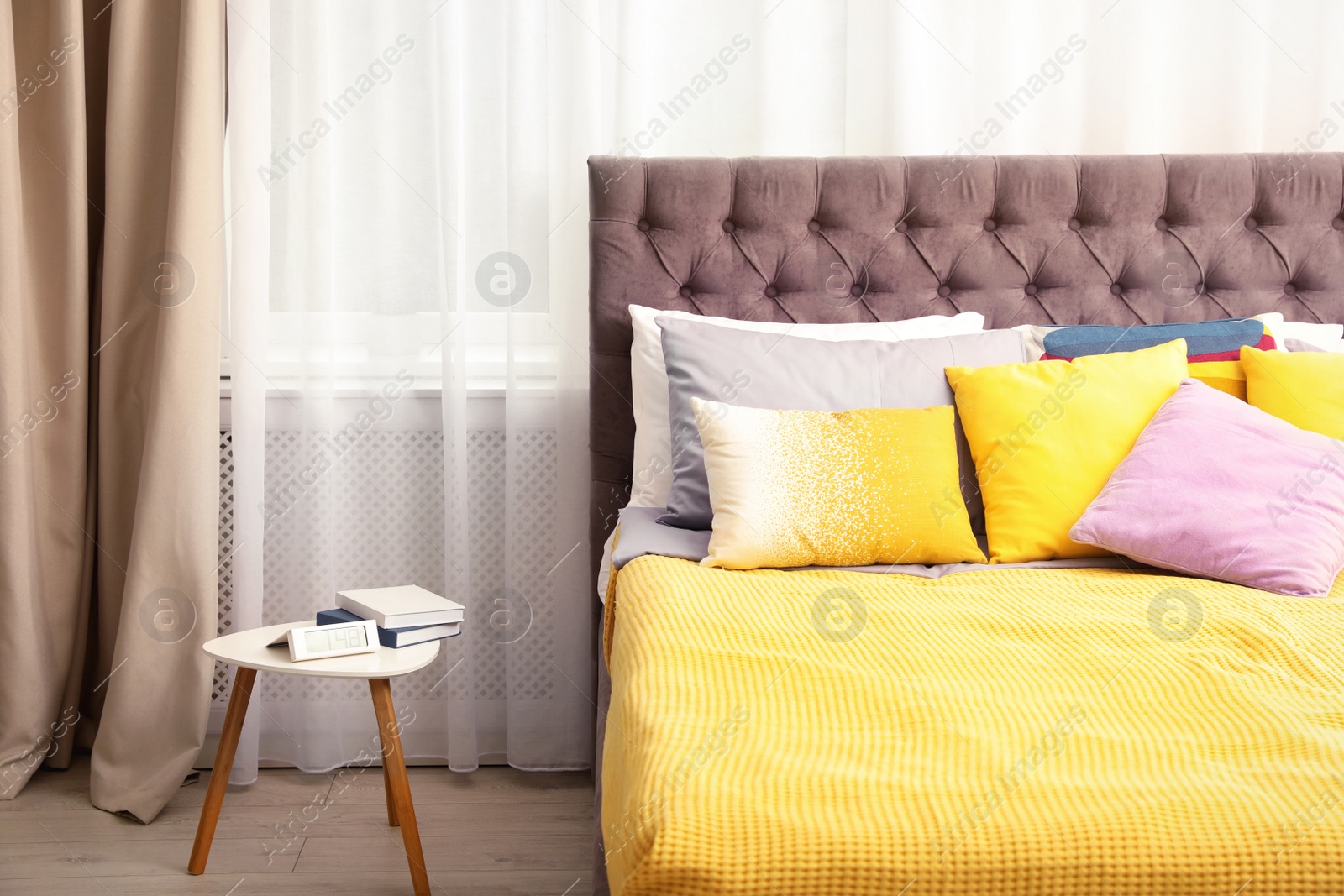 Photo of Different pillows on bed in room. Idea for interior decor