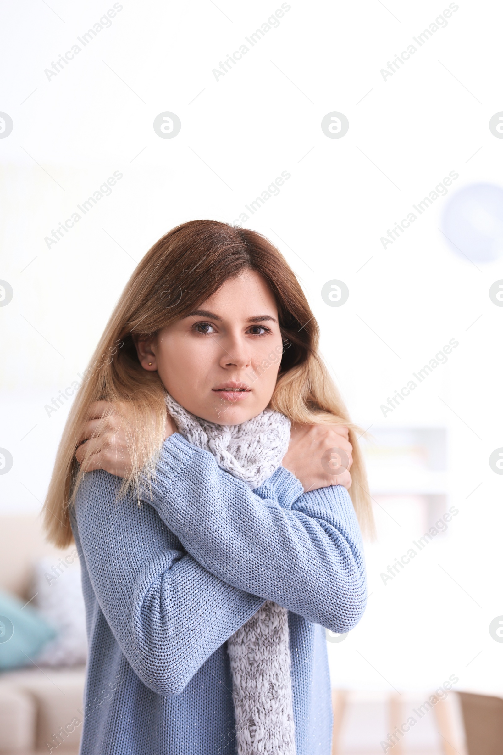 Photo of Sad woman suffering from cold on blurred background