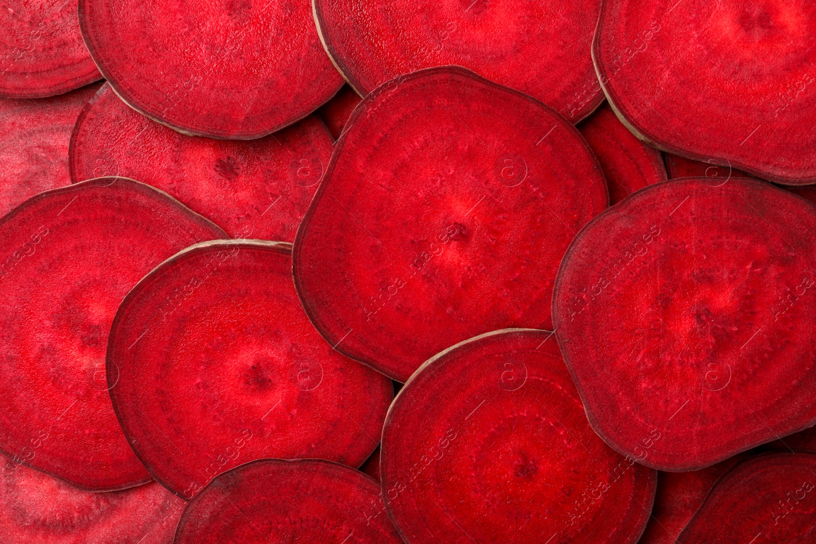 Photo of Slices of fresh beets as background, top view