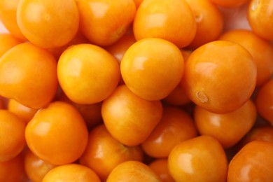 Fresh ripe physalis fruits as background, closeup view