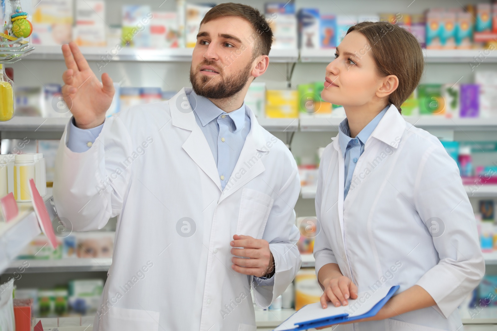 Image of Professional pharmacists working together in modern drugstore