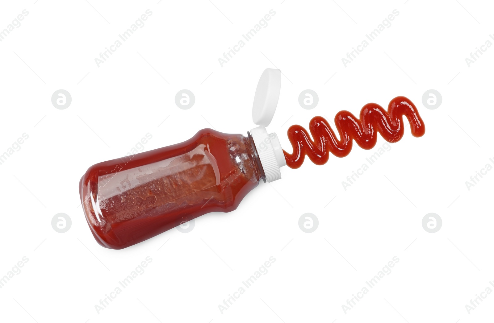 Photo of Squeezed ketchup from bottle isolated on white, above view