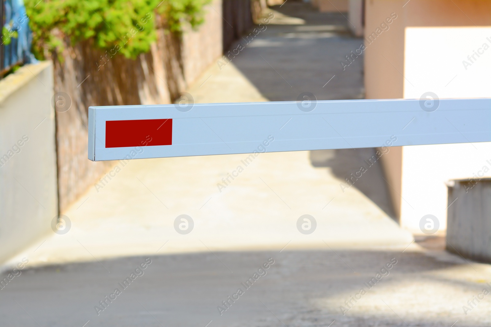 Photo of Closed boom barrier on sunny day outdoors, closeup