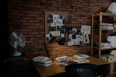 Photo of Detective workplace near brick wall in office