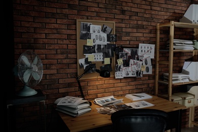 Detective workplace near brick wall in office