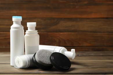 Composition with shoe care accessories on wooden table. Space for text