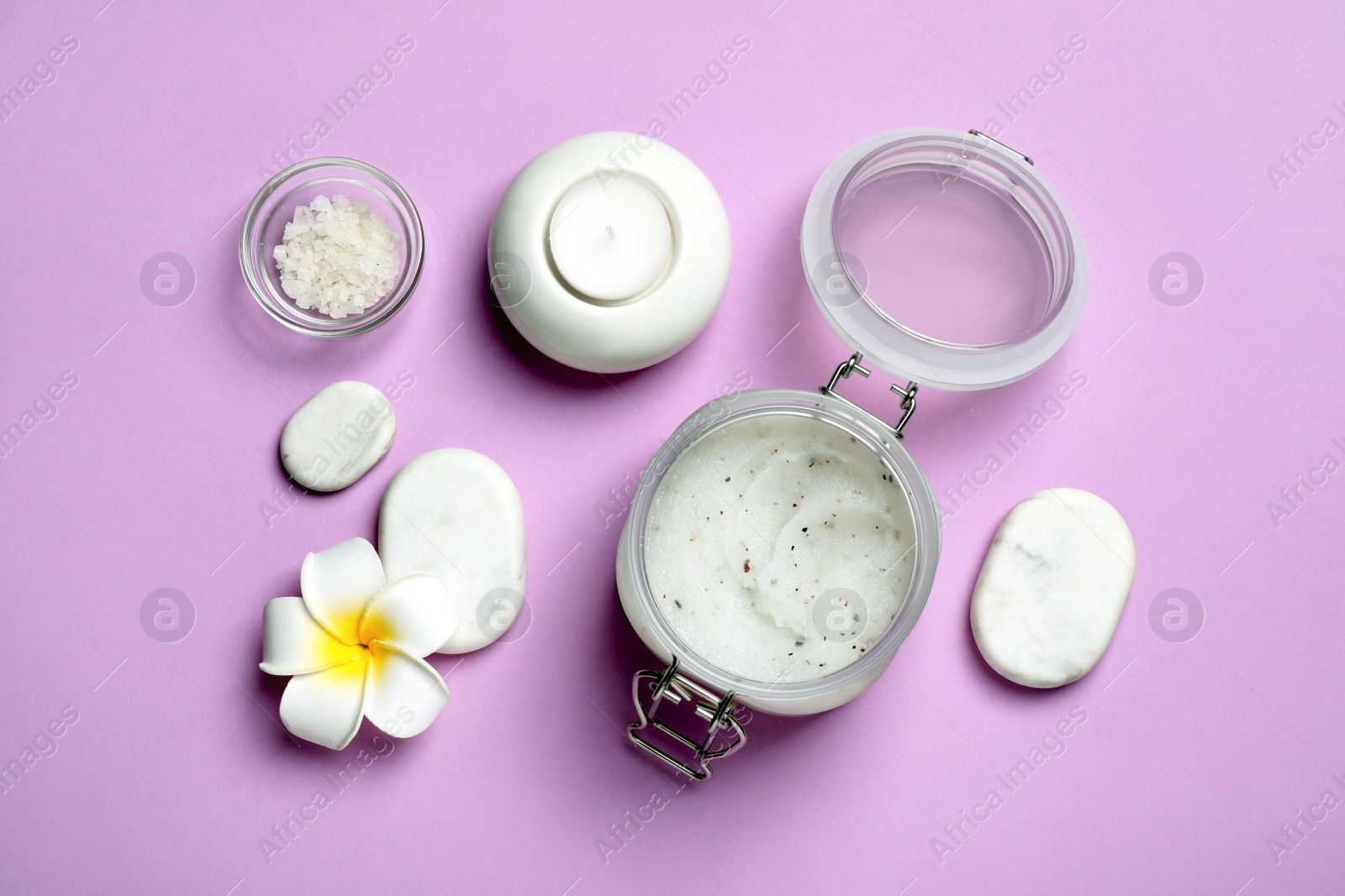 Photo of Flat lay composition with body scrub and plumeria flower on pale violet background
