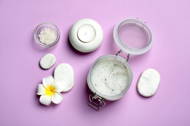 Flat lay composition with body scrub and plumeria flower on pale violet background