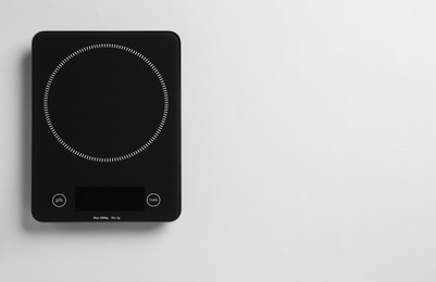 Photo of Modern digital kitchen scale on white background, top view. Space for text