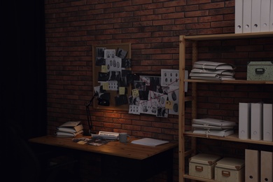 Photo of Detective workplace near brick wall in office