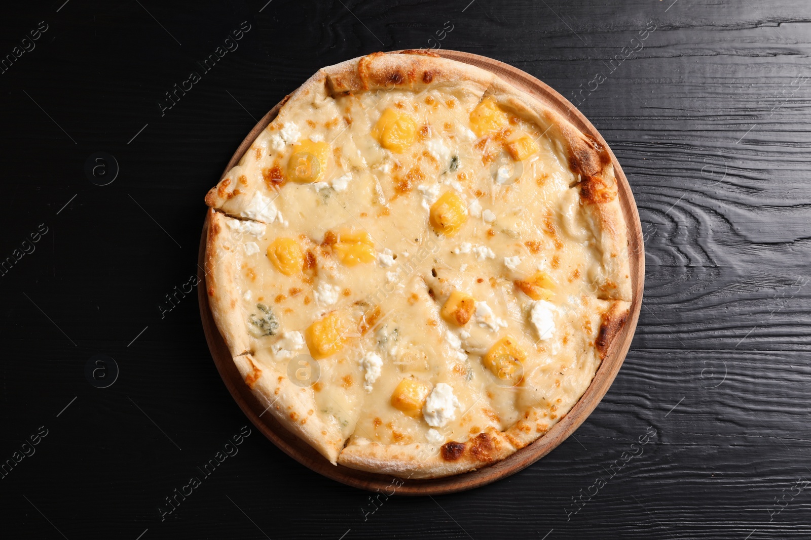 Photo of Hot cheese pizza Margherita on wooden table, top view