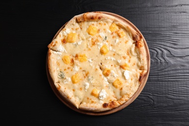 Photo of Hot cheese pizza Margherita on wooden table, top view