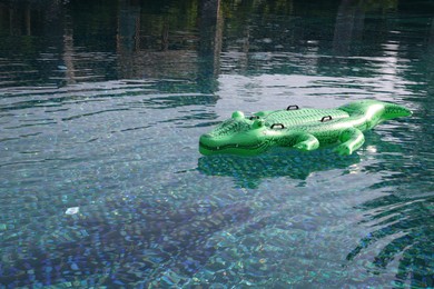 Photo of Float in shape of crocodile in swimming pool outdoors