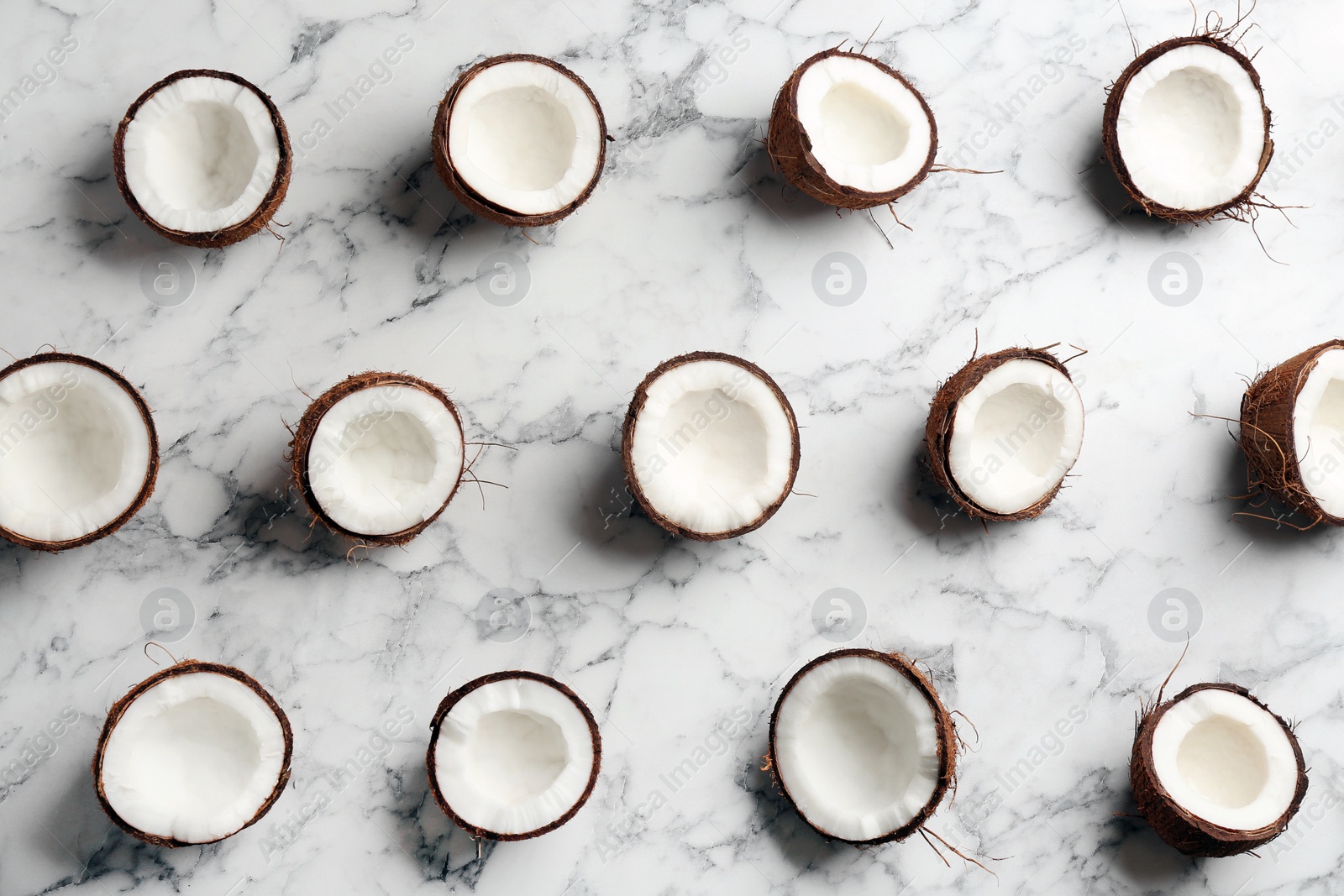 Photo of Coconut pattern on marble background, flat lay