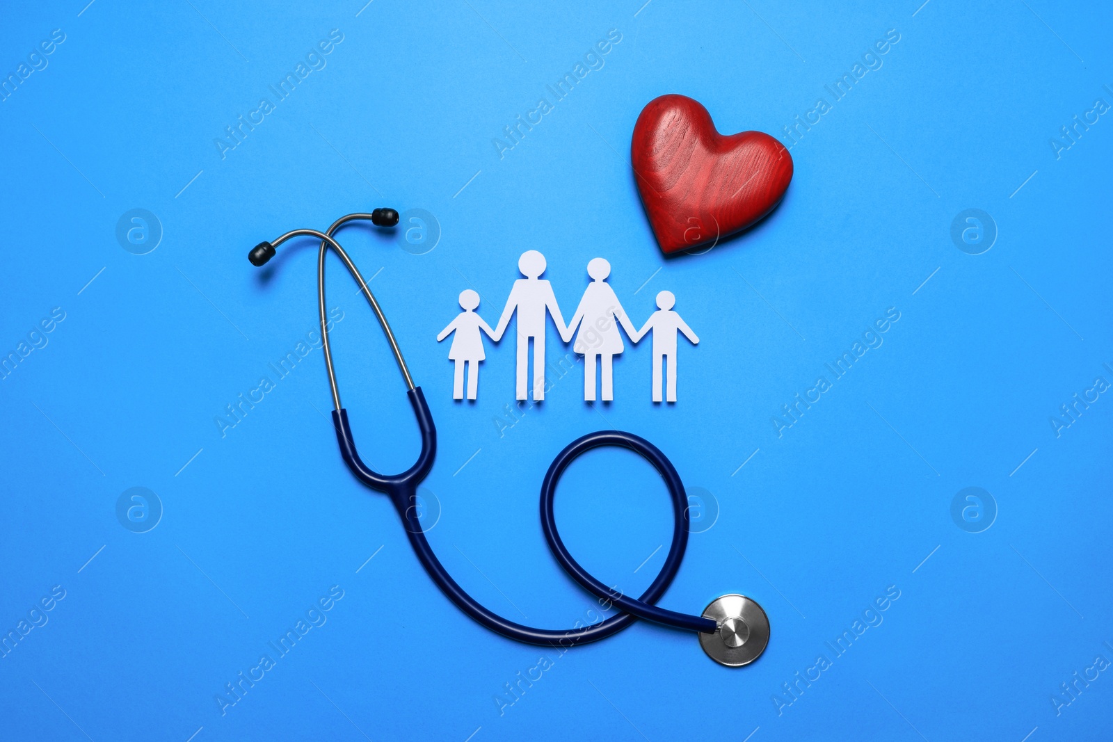 Photo of Paper family cutout, stethoscope and red heart on light blue background, flat lay. Insurance concept