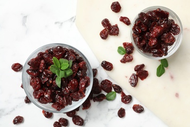 Photo of Flat lay composition with tasty dried cranberries on white marble table