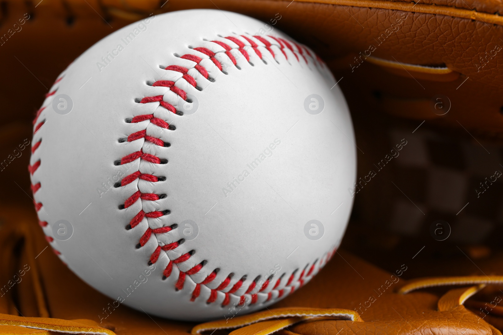 Photo of Leather baseball glove with ball, closeup. Sportive equipment