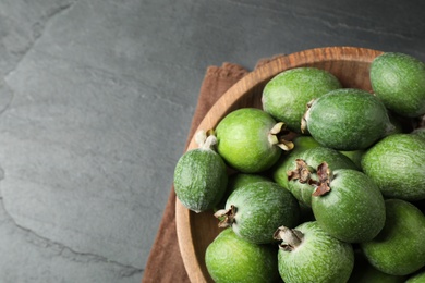 Delicious fresh feijoas on black table, above view. Space for text