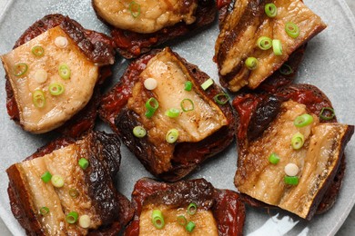 Photo of Tasty sandwiches with fried pork fatback slices on plate, top view