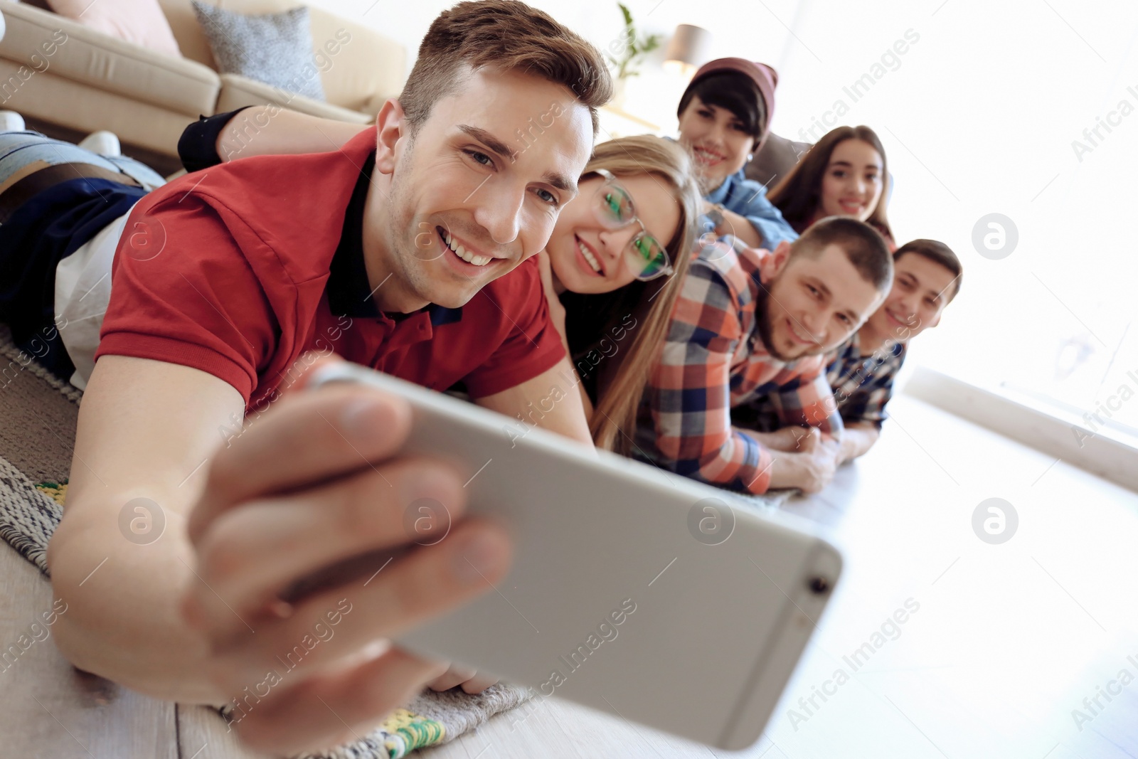 Photo of Happy friends taking selfie indoors