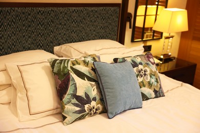 Photo of Beautiful pillows on bed in hotel room