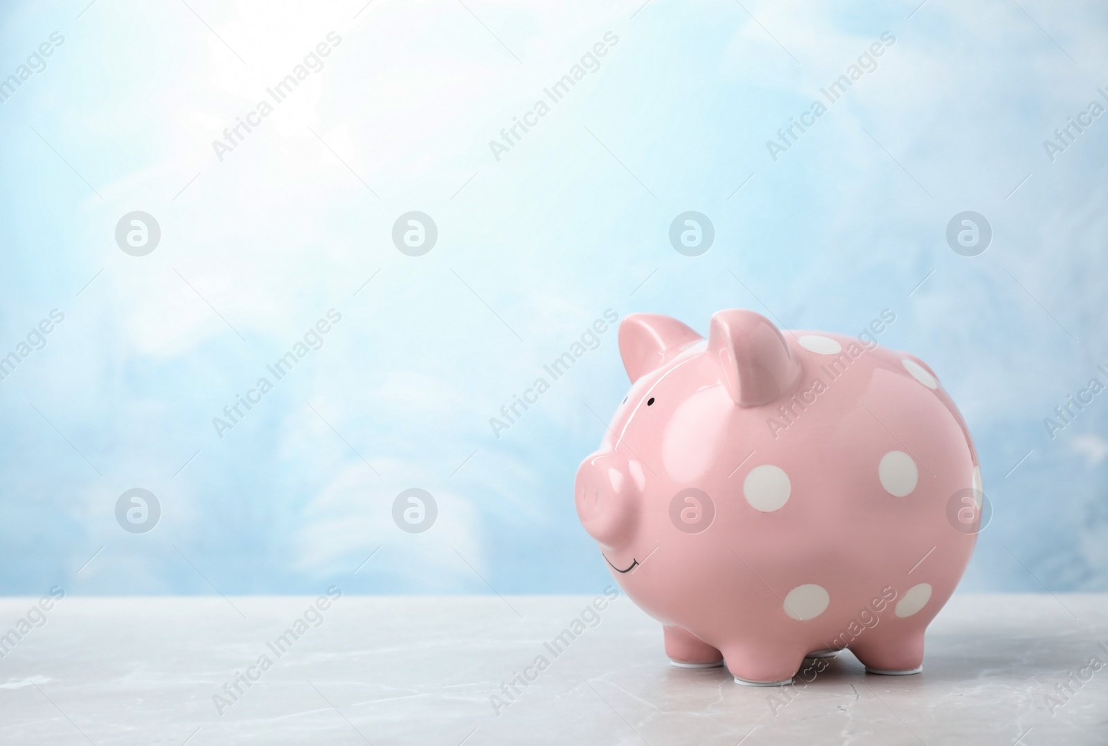 Photo of Pink piggy bank on table. Money saving