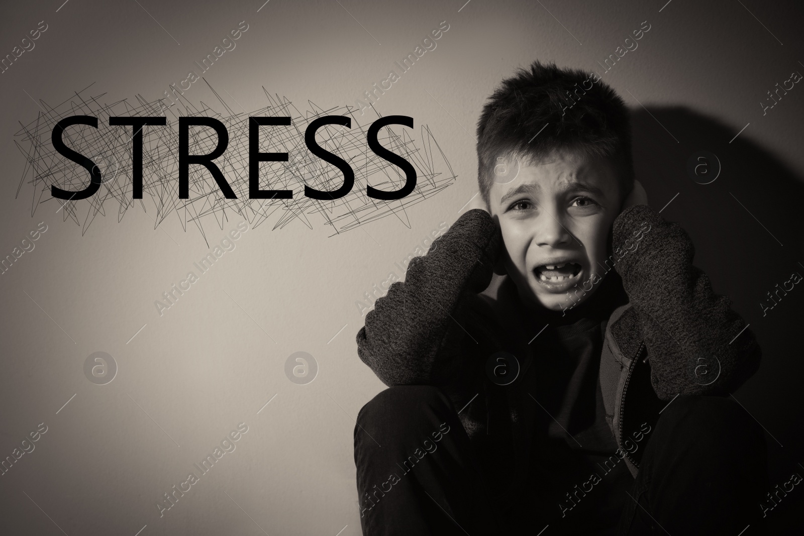 Image of Word STRESS and scared little boy near beige wall