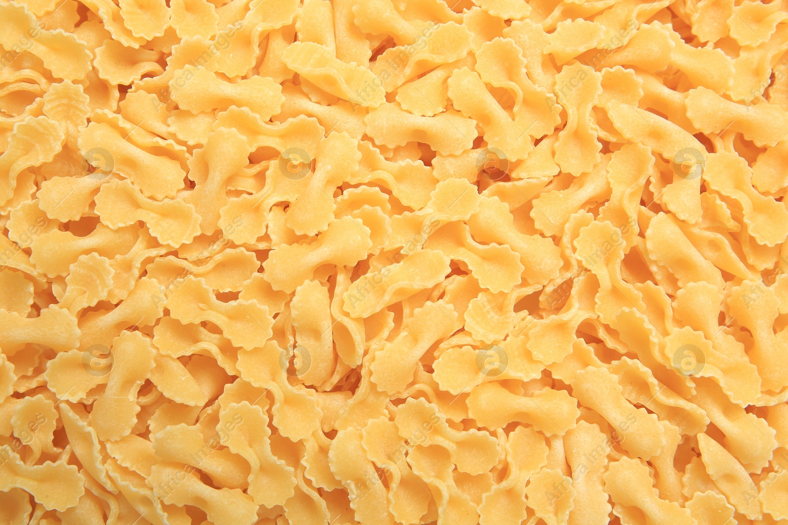 Photo of Raw farfalle pasta as background, top view