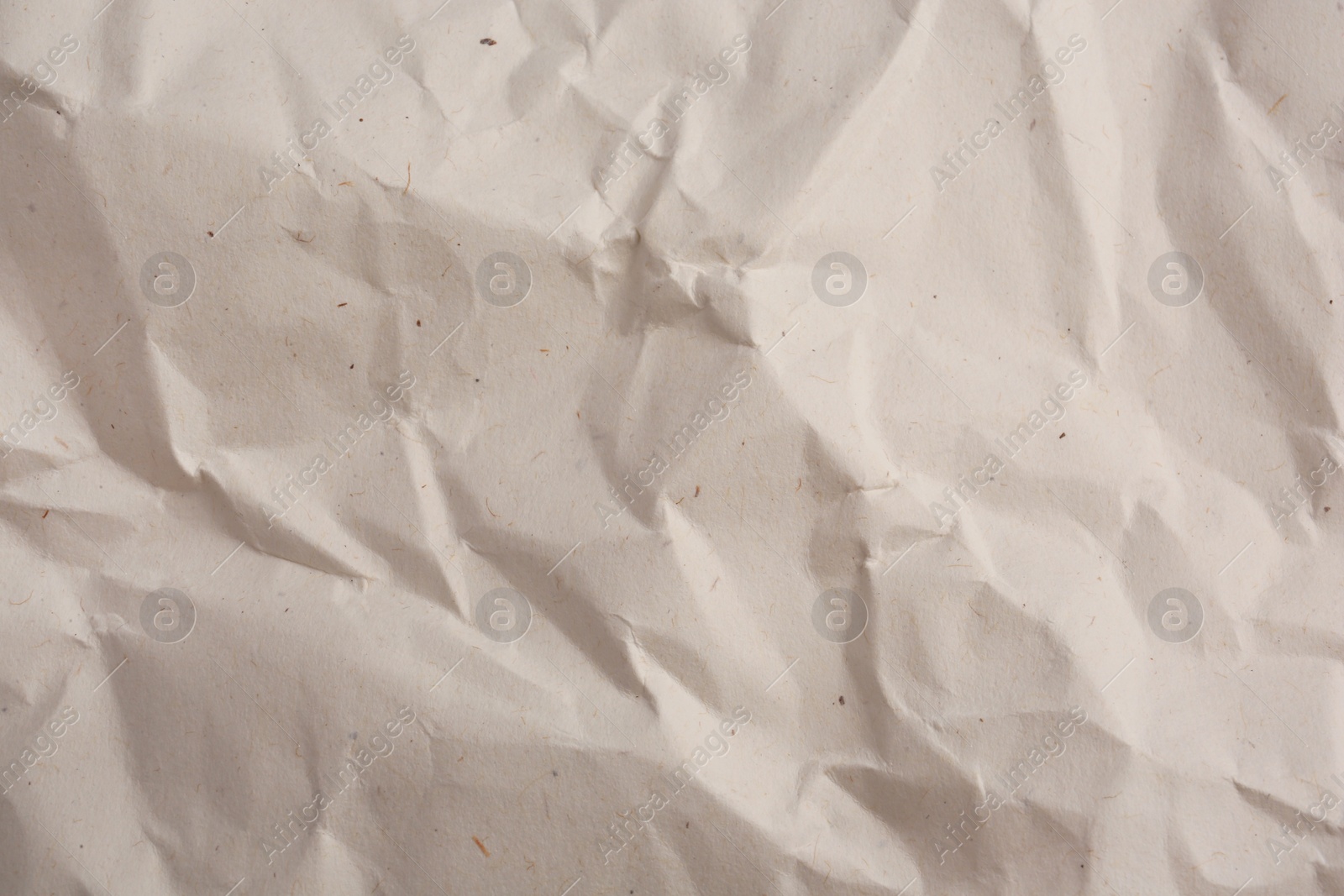 Photo of Texture of crumpled parchment paper as background, top view