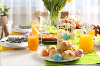 Festive Easter table setting with traditional meal at home, space for text