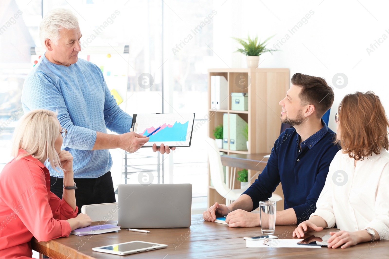 Photo of Group of people discussing ideas at table in office. Consulting service concept