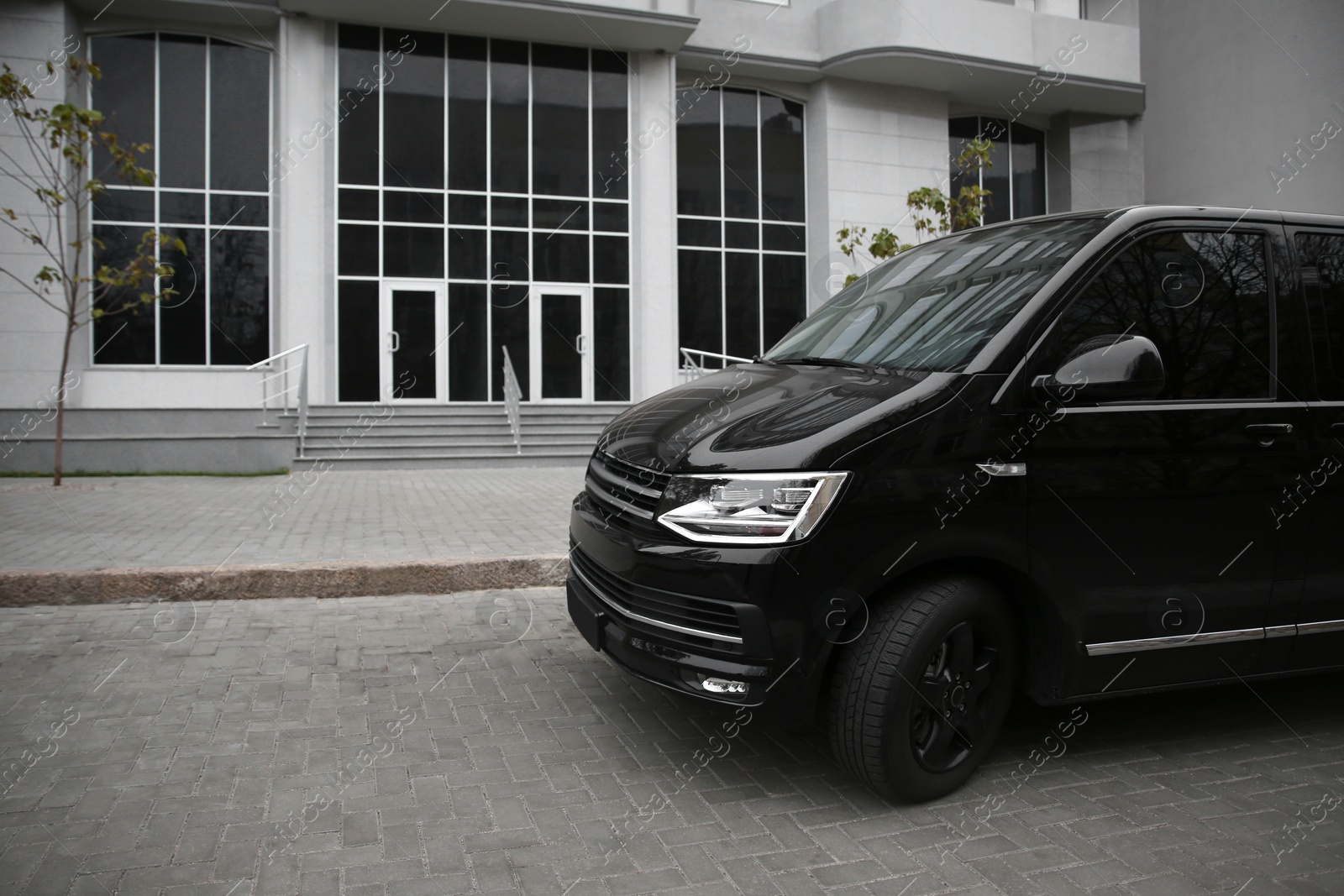 Photo of Black delivery van parked on street near building