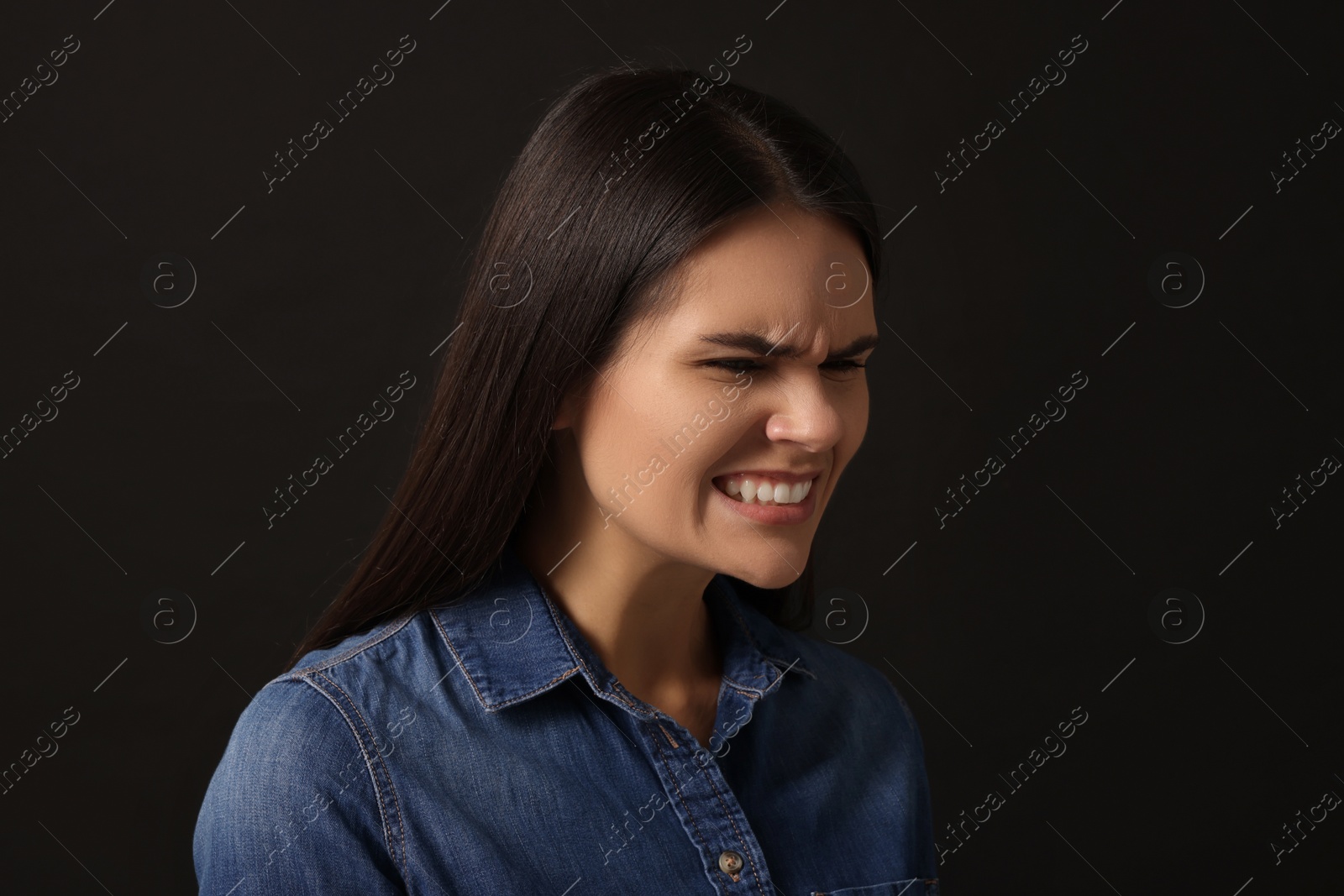 Photo of Personality concept. Emotional woman on black background