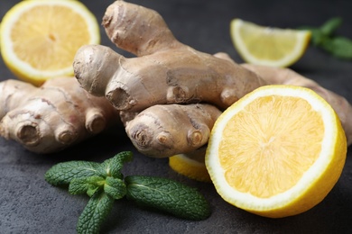 Fresh lemon, ginger and mint on grey table, closeup