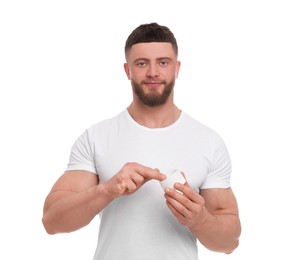 Photo of Handsome man applying body cream on white background