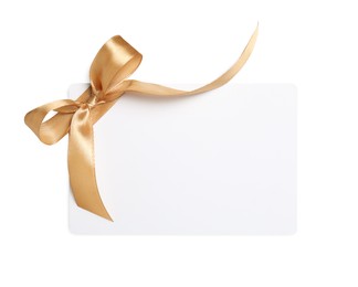 Blank gift card with golden bow isolated on white, top view