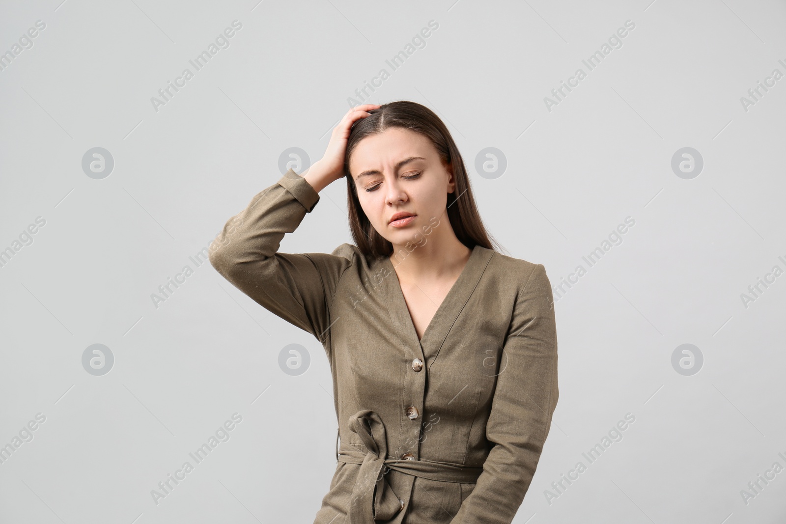 Photo of Portrait of young woman on light grey background. Personality concept