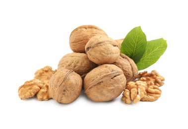 Photo of Pile of ripe walnuts and leaves on white background