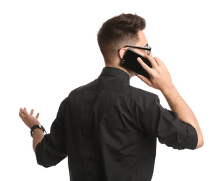 Young businessman talking on smartphone against white background