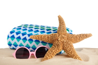 Photo of Beach accessories on sand against white background