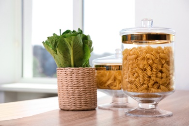 Products in modern kitchen glass containers on wooden table